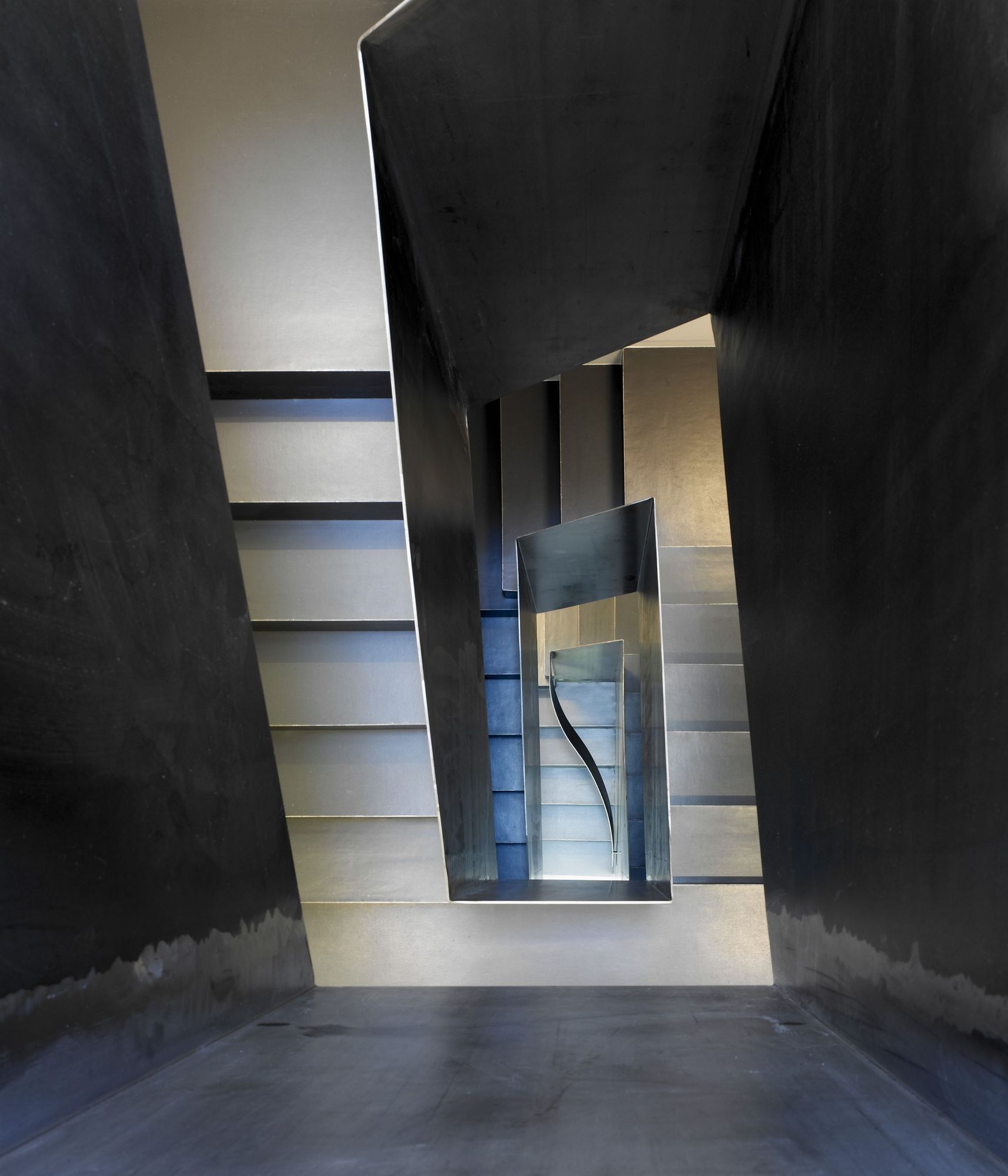 The new steel stair flows freely across floors.