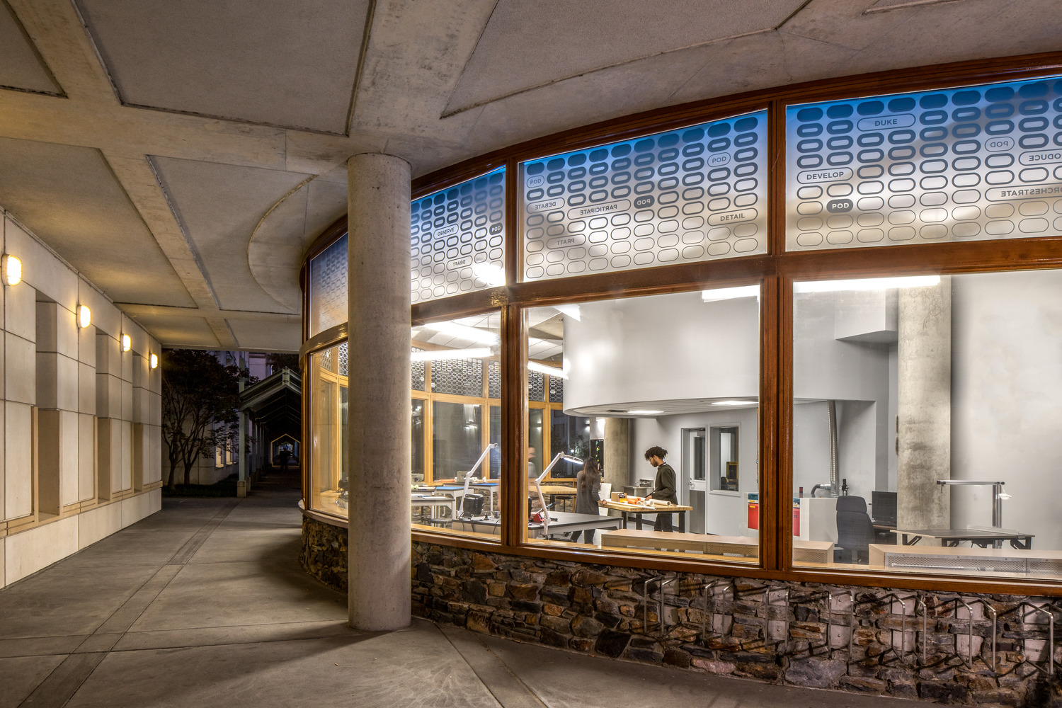 The back of the space contains laser cutters and power tools within the gray inner volume.