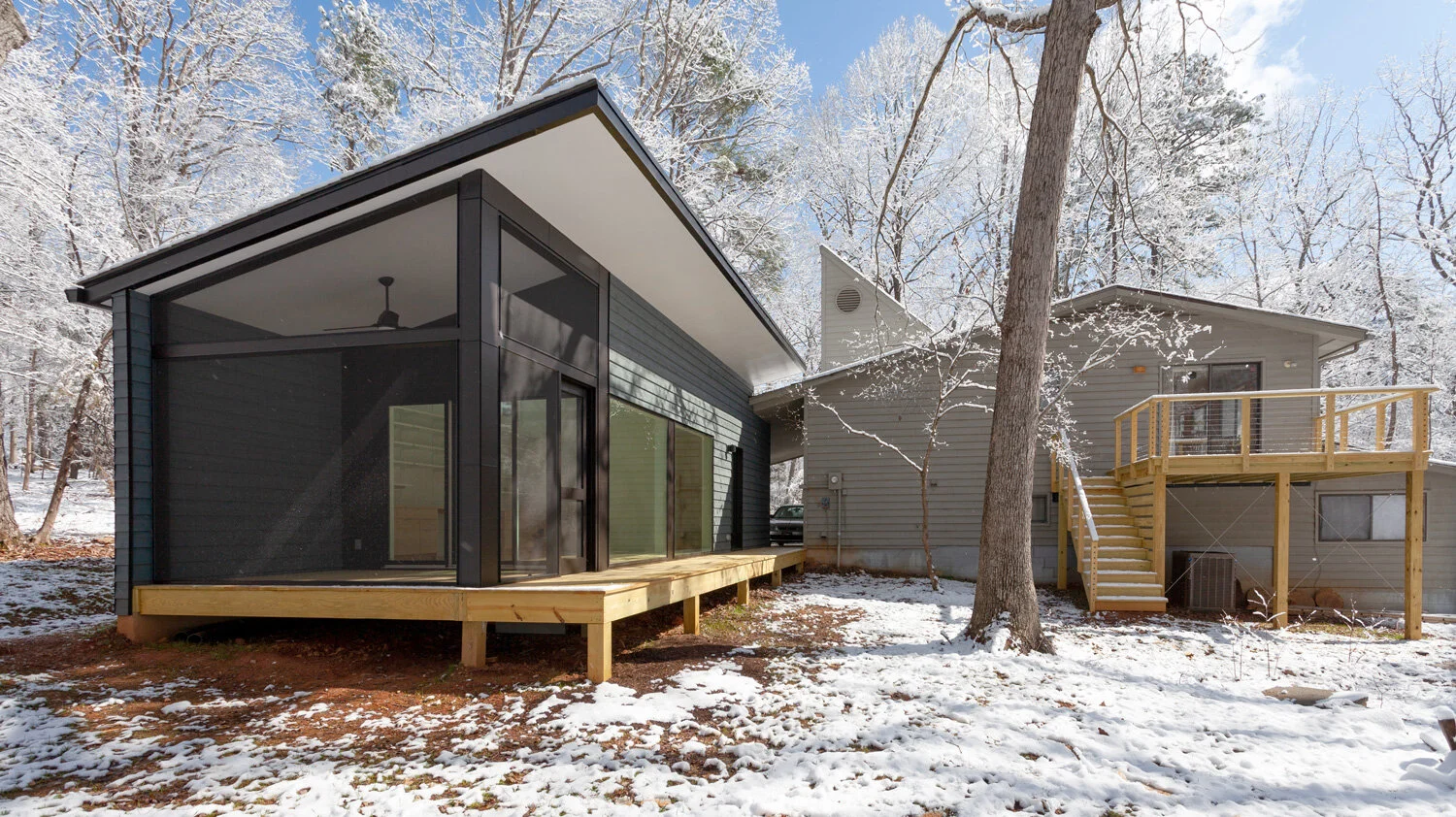  The addition and new deck create a courtyard-like feel and  maximize enjoyment of the wooded lot.  