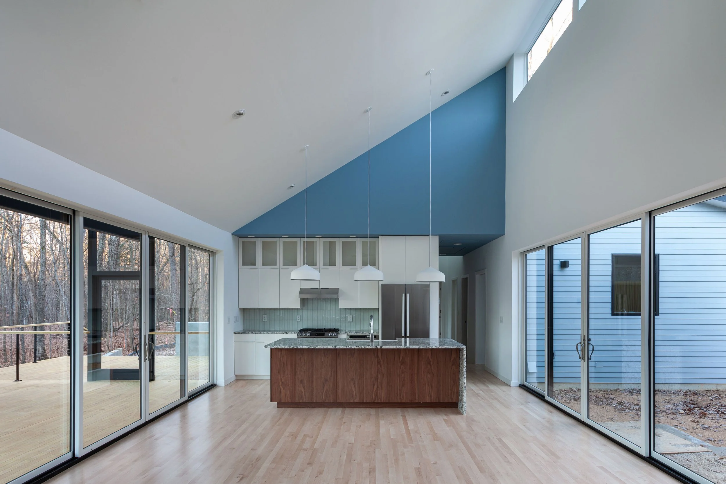  The heart of the house opens to a private courtyard  (right) and views to surrounding forest (left). 