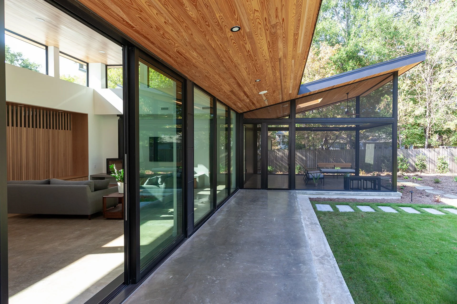 Sloped soffit and screened porch roof align, opening dramatic unobstructed views and from inside.