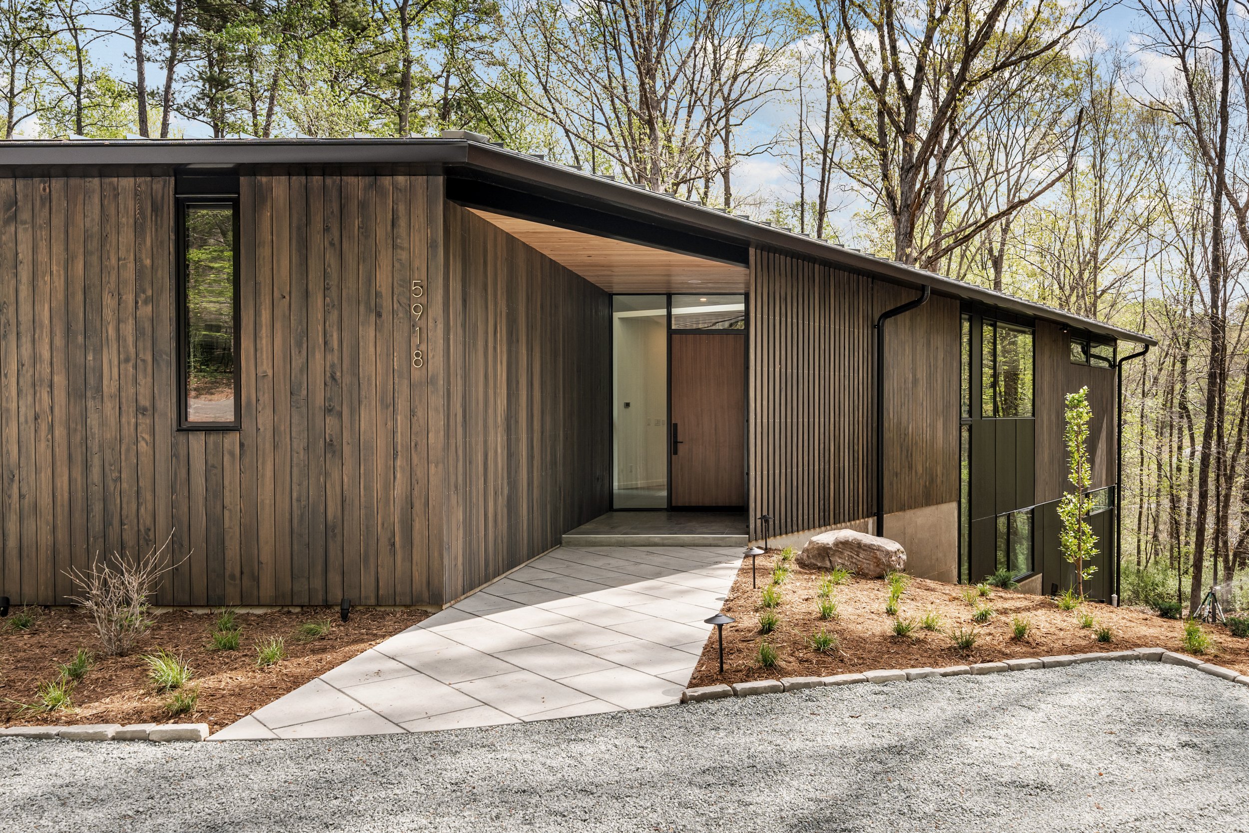  The front entrance is visually screened, tucked into the corner of the angled floor plan. Surprises unfold within. 