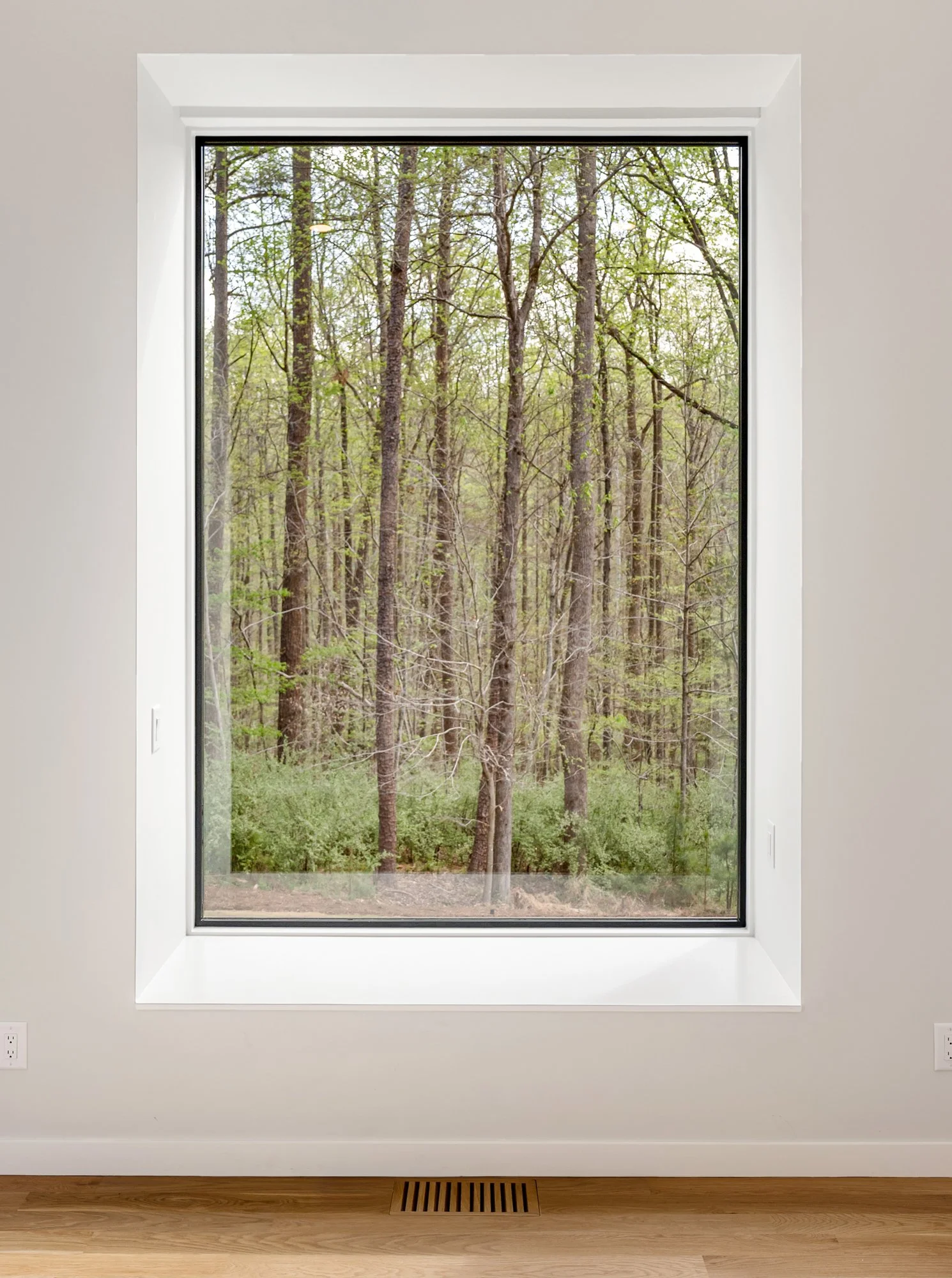  A projecting window seat in the primary suite creates a cozy nook, and frames the forest view. 