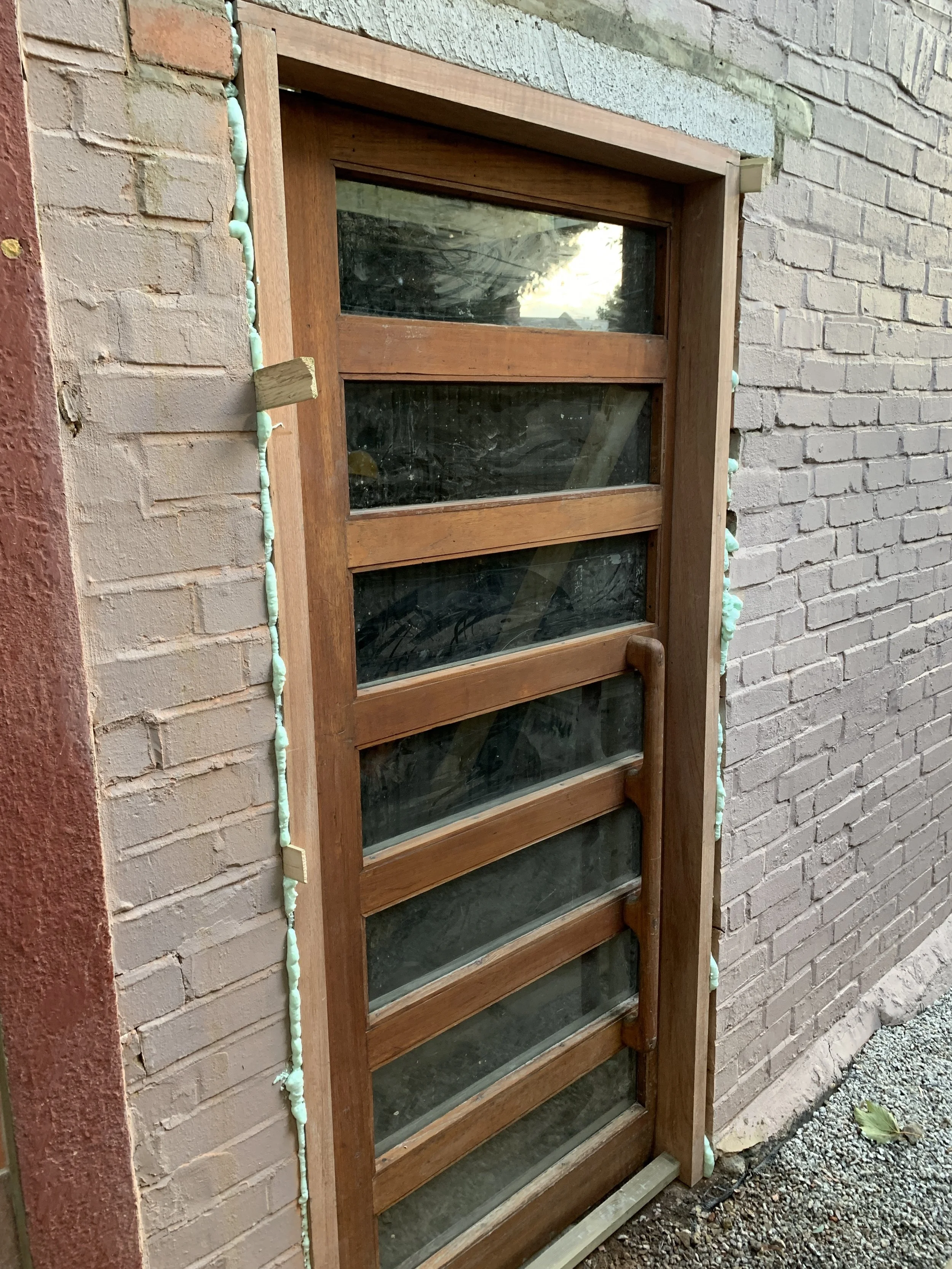 Fitting modernist salvaged door from the decommissioned Cumberbatch building at Trinity College, Oxford