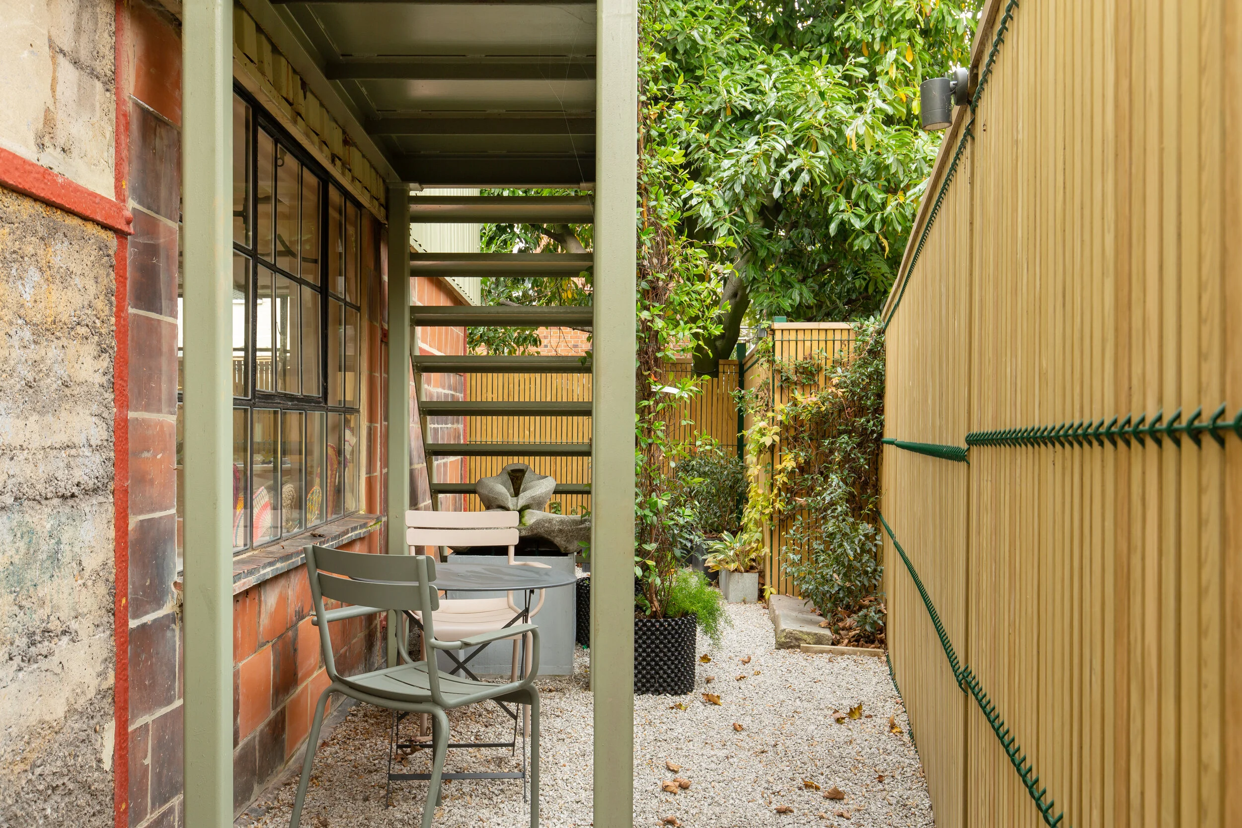 Shelter under the sage green fire escape