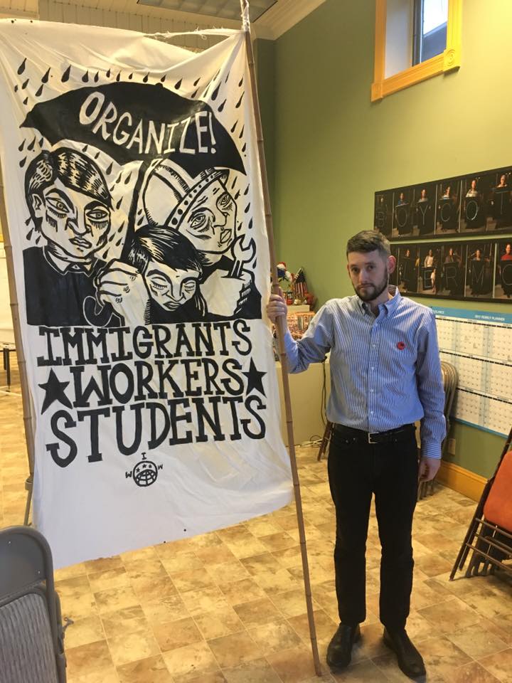  Organizer Elliott Majors holds a finished banner.  