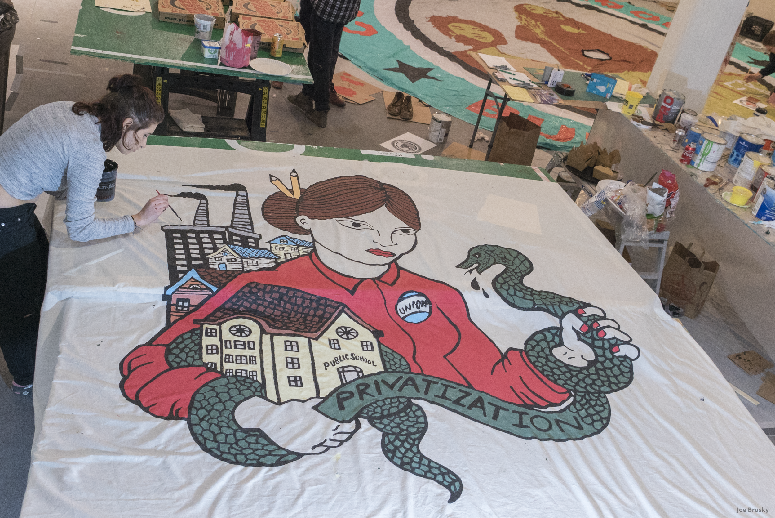  Pro Public Education banners, parachutes, and screen printed picket signs are produced at an art build with Milwaukee Teachers Education Association.  