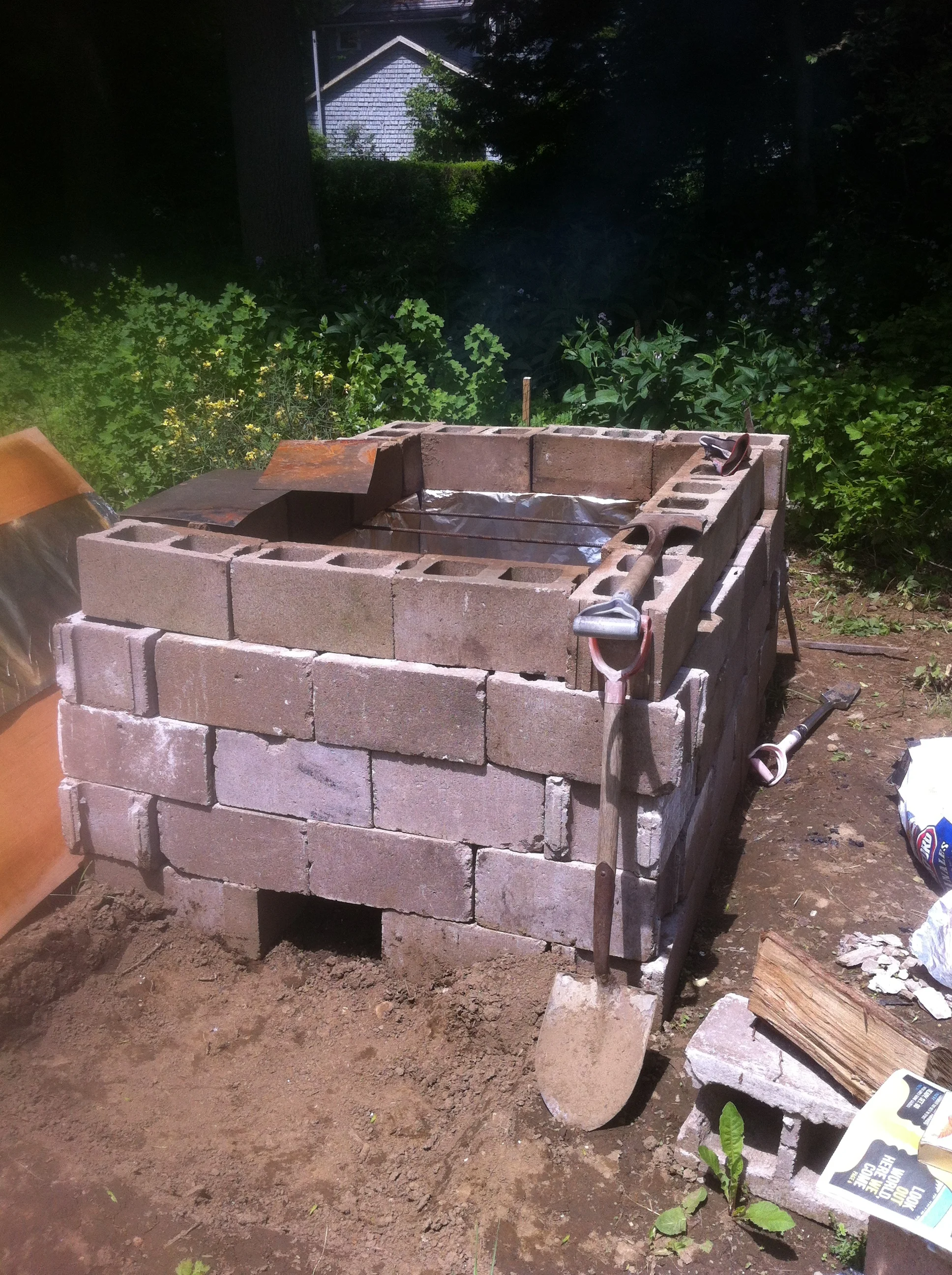  Pit ready for load in. Sheets of metal used as a heat shield. I eventually abandoned this idea. 