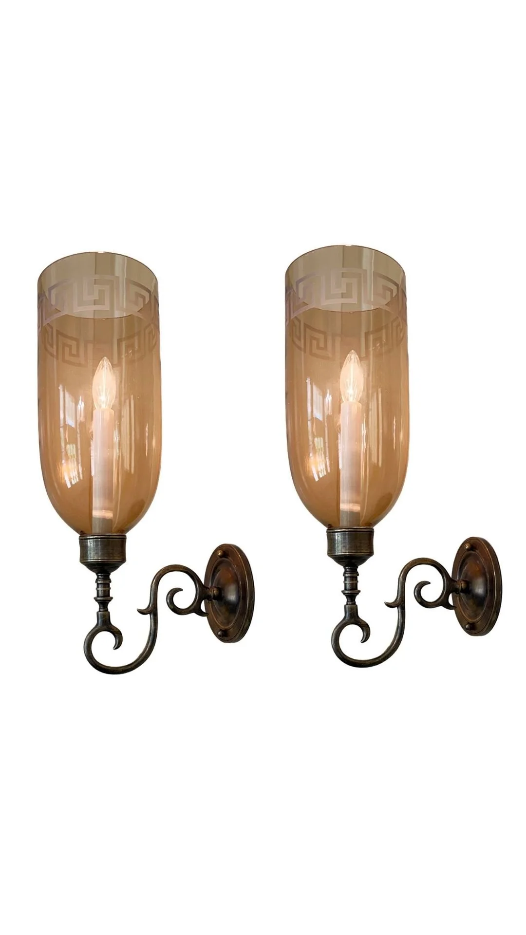A Pair of Sconces with Amber Etched Hurricane Shades