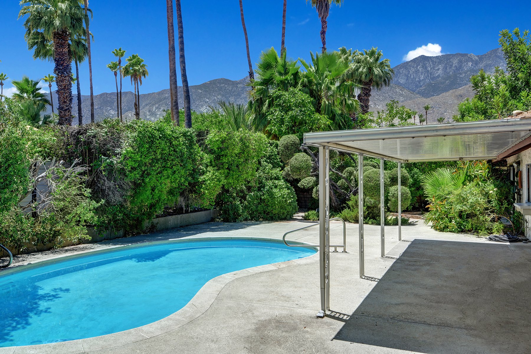 BACK COVERED PATIO TO POOL AND MOUNTAINS MLS.jpg