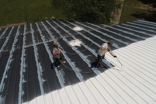 two men working on top of commercial roof