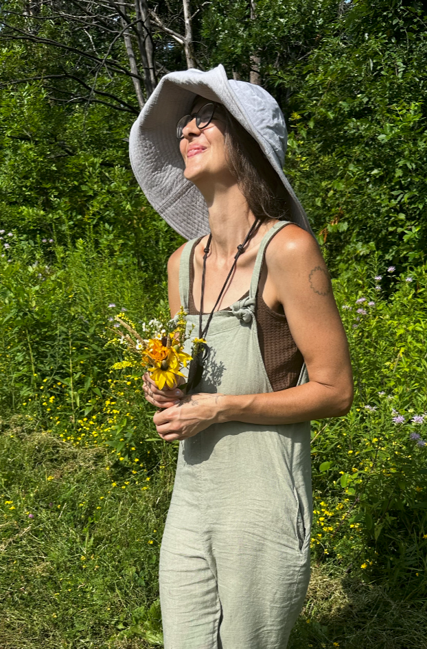 Landscaper holding wildflowers, woman in the garden, gardening services, beauty, nature, sunlight, minneapolis gardens