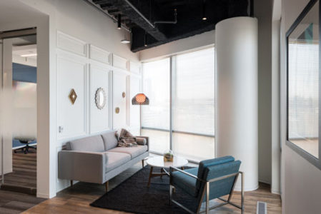  Facility space at the Capital One office is maximized by tucking soft seating into an open corner for a cozy spot in which to relax or socialize. (Photos: Adam Auel Photography, courtesy of Capital One)   