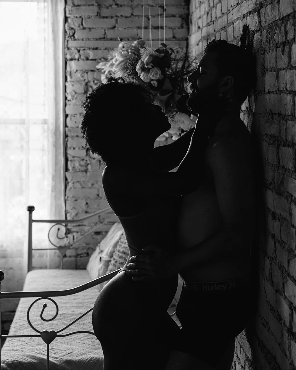Close-up of a couple embracing during a cinematic erotic photography session by a Toronto erotic photographer.