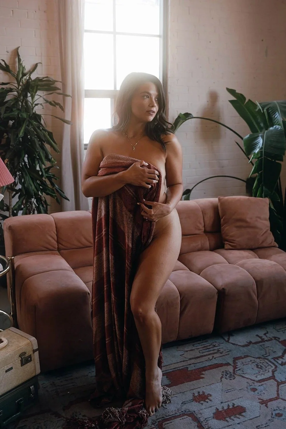 Woman standing with blanket at a toronto boudoir photography studio