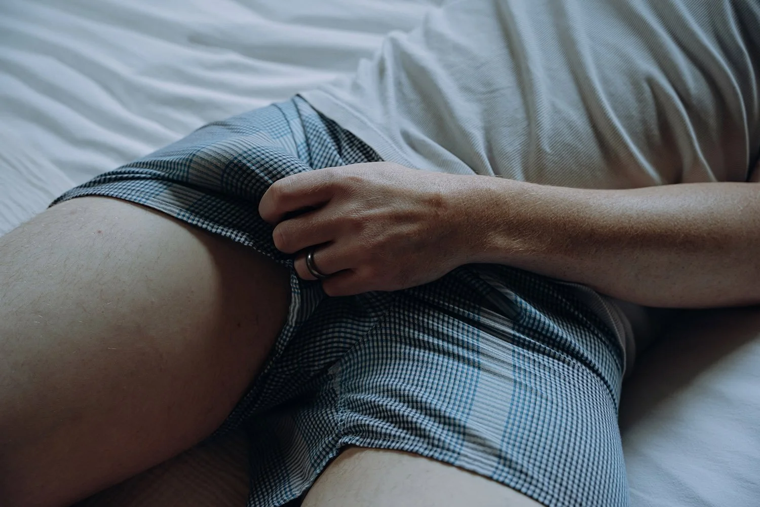 Man holding his hard member while posing during a male erotic shoot in Hamilton, Ontario