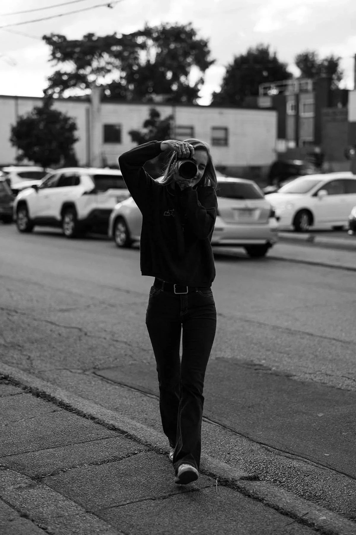 Boudoir photographer in Hamilton and Toronto holding her camera up for a photoshoot