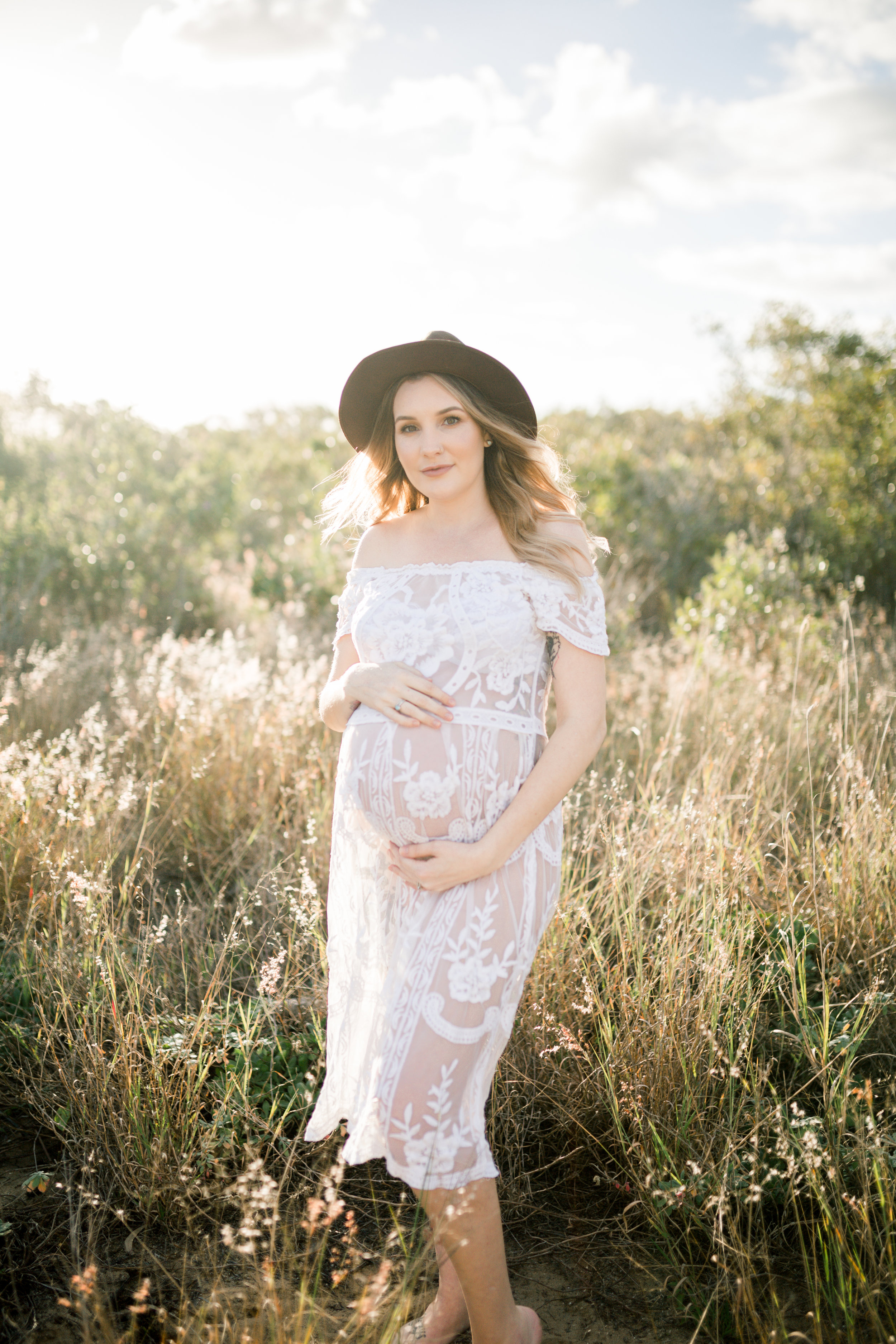 Maternity photo of a mother wearing lace gown