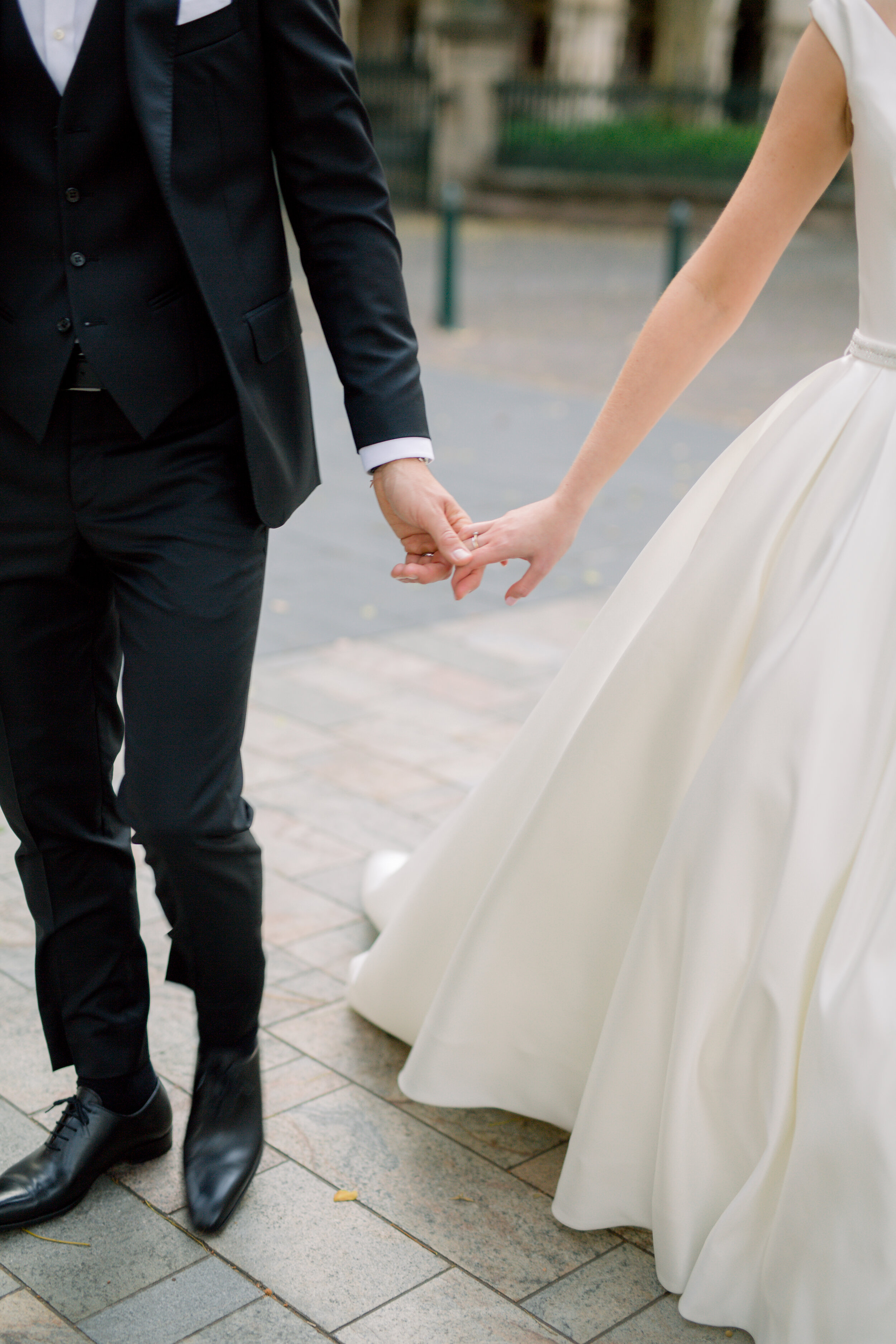 details shot or a bride and groom holding hands