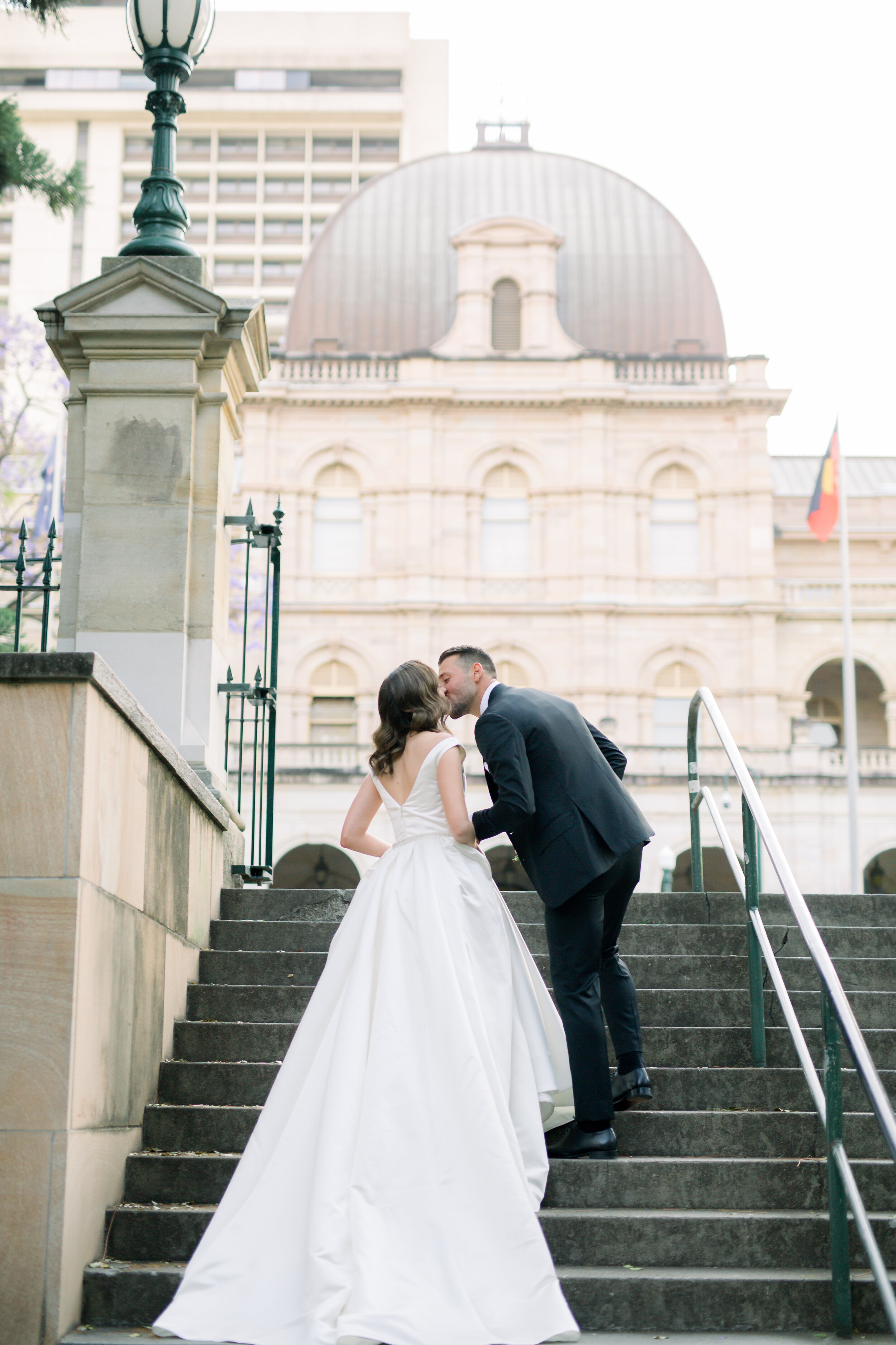 bride and groom walking up the stairs