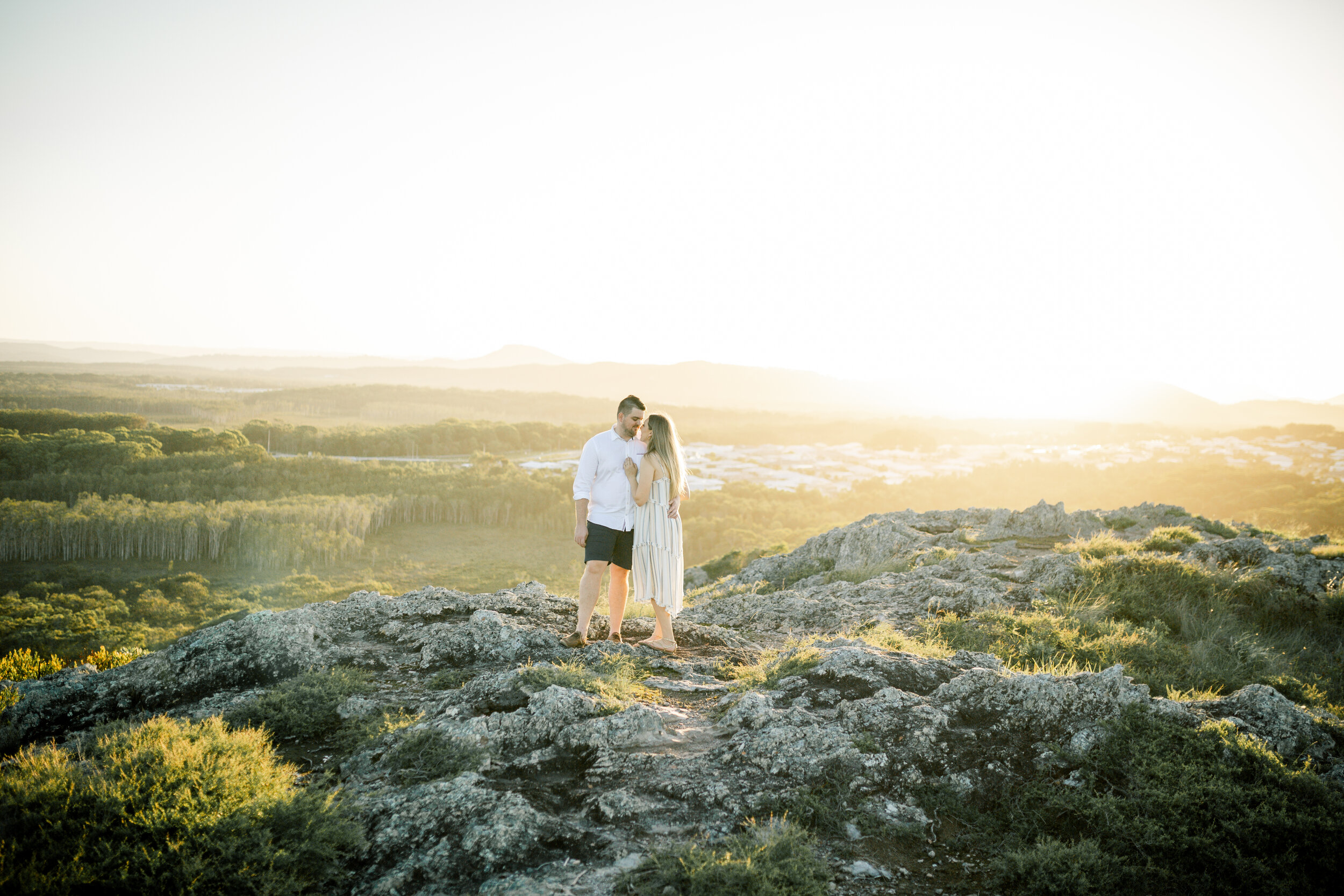 couple standing on the top of a mountain