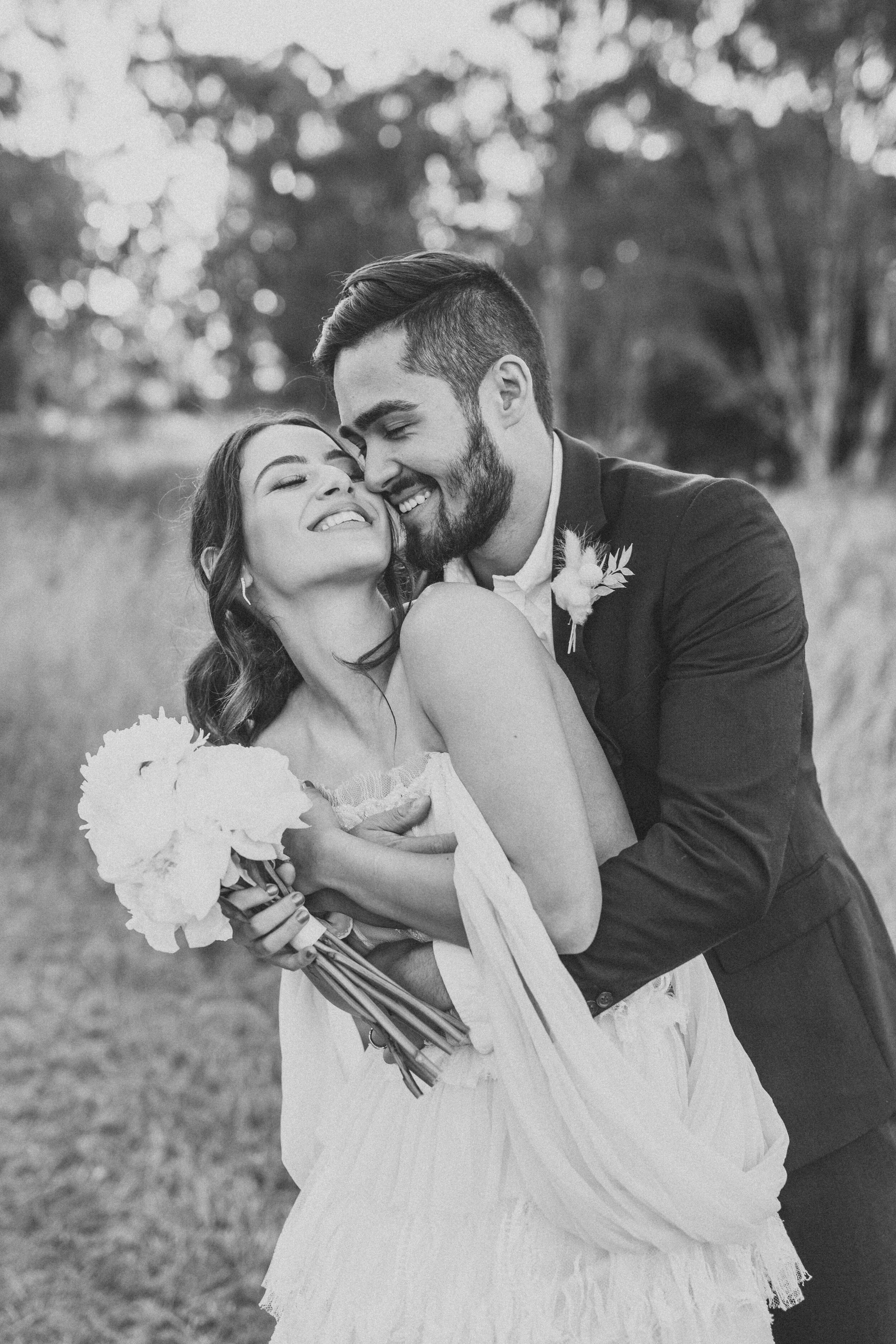 Black and white protrait of a wedding couple happily embracing each other