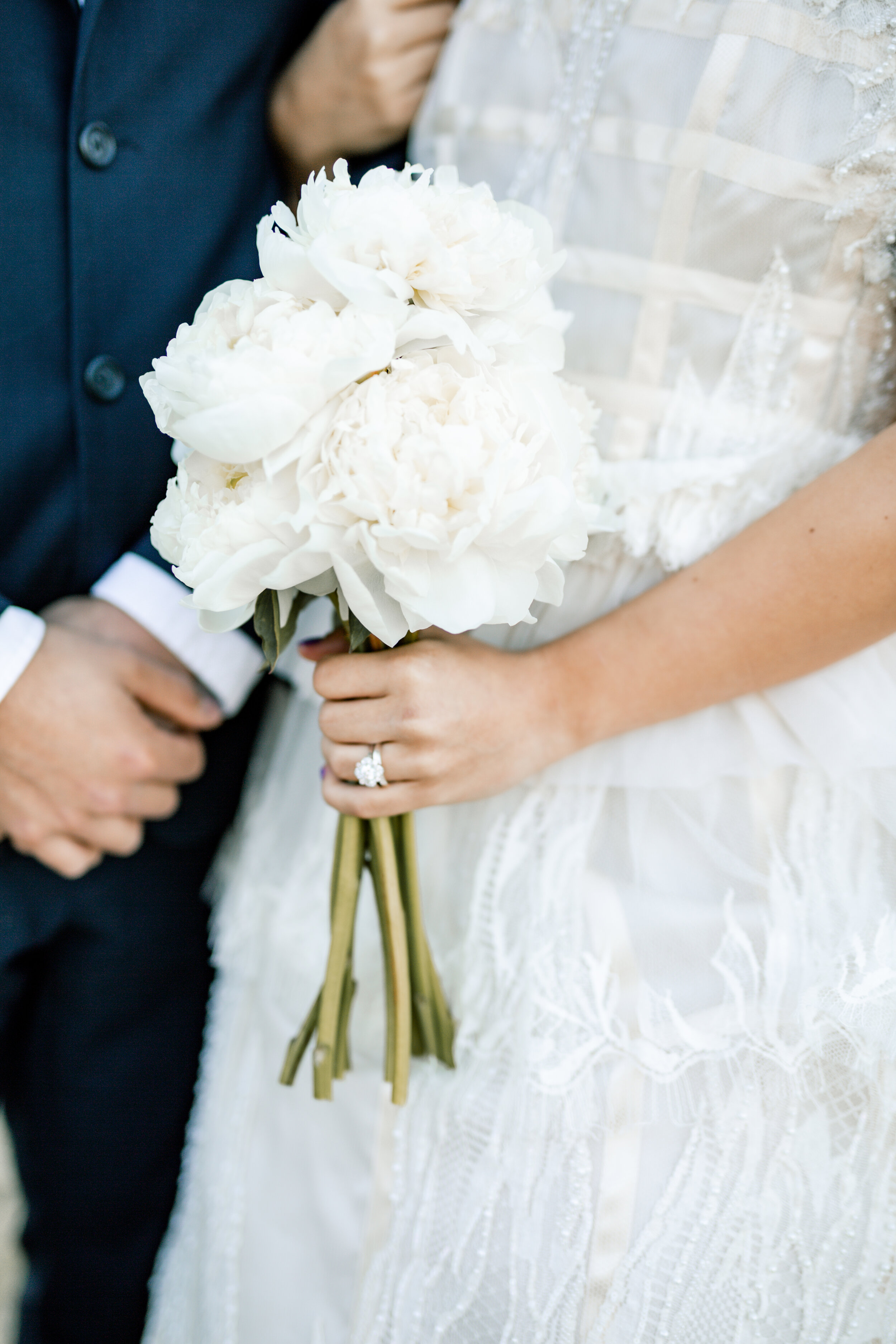 Bride holding Groom's arm and a bridal bouquet