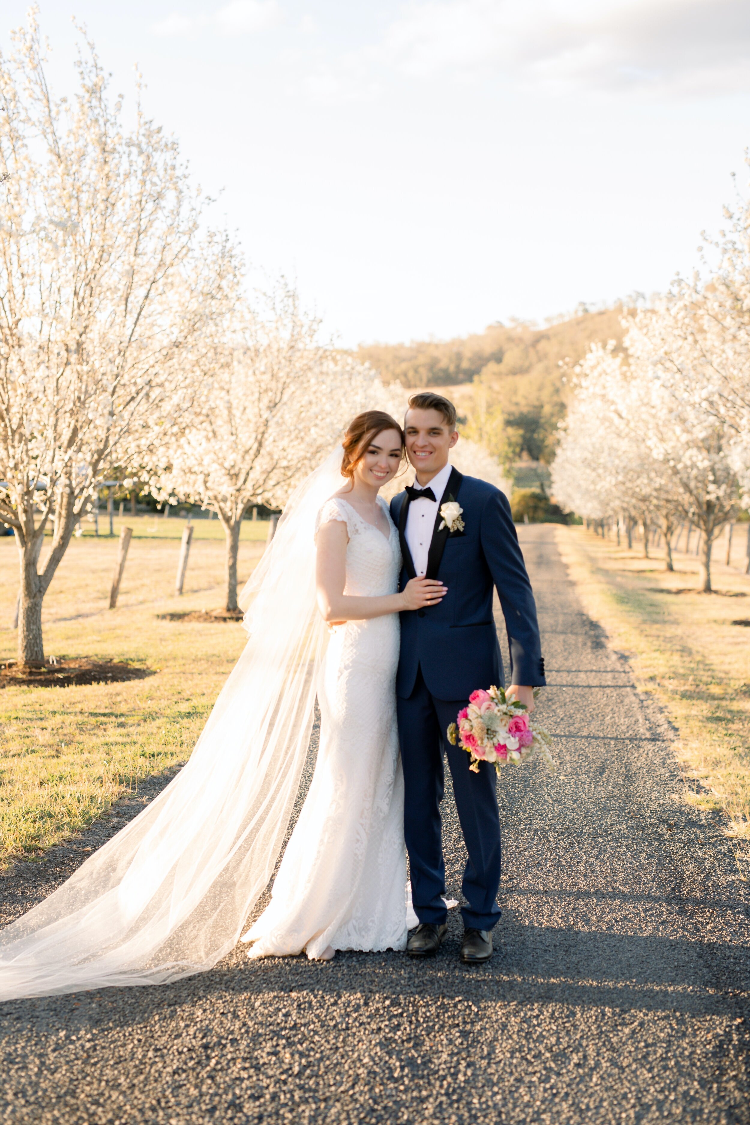 Toowoomba wedding Bride and Groom among the blossom trees