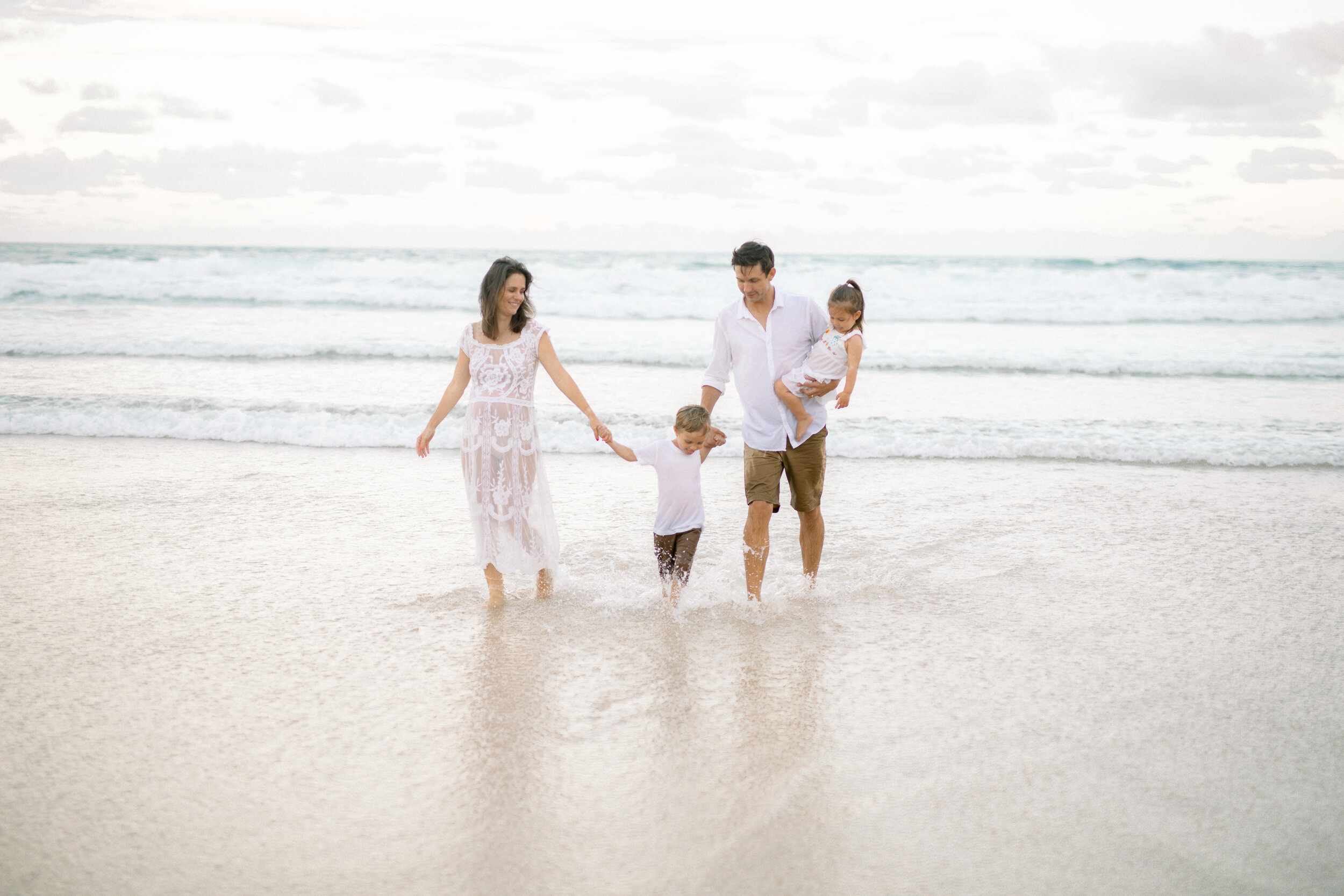 Family photographed by in the waves