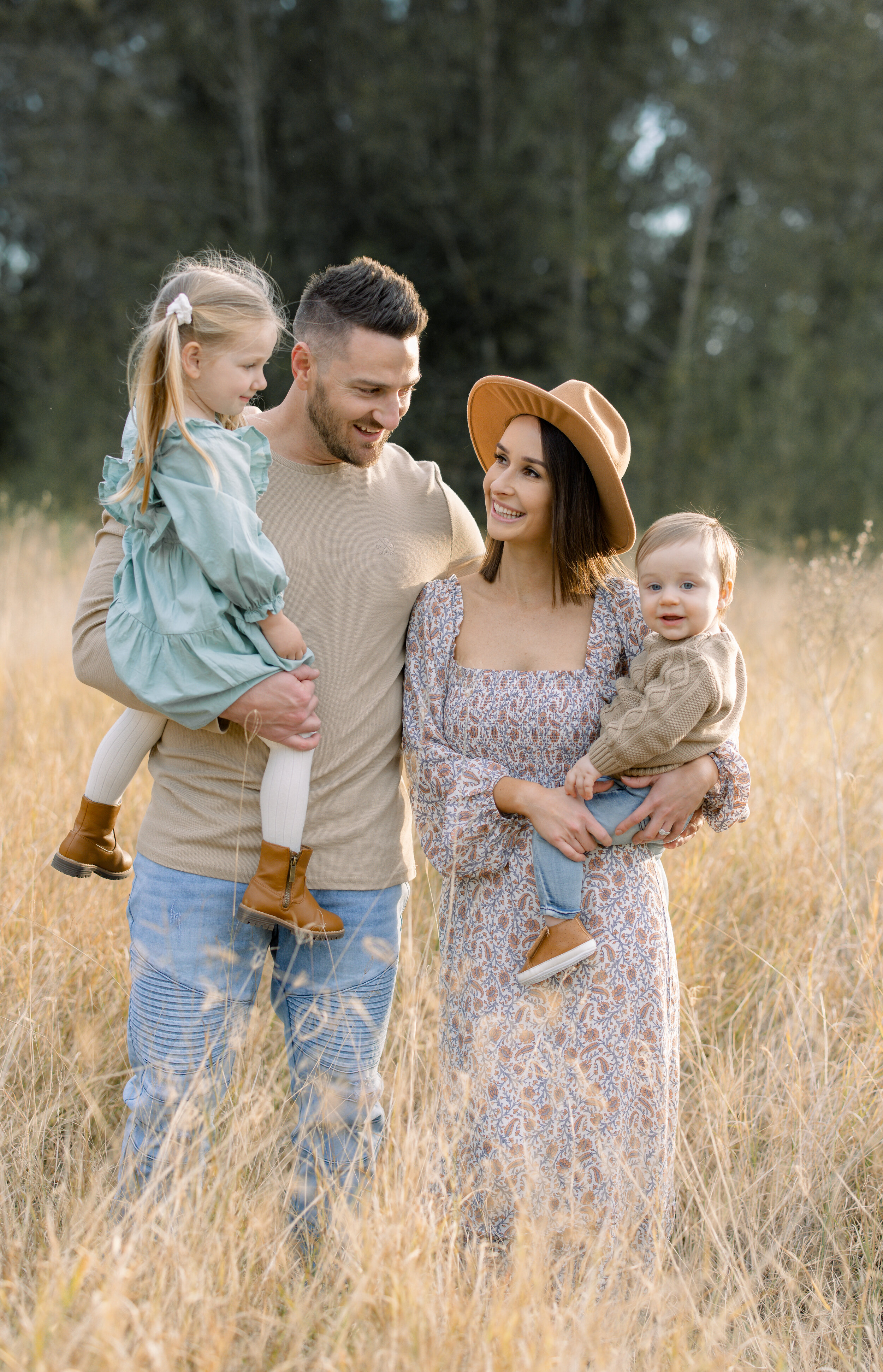 Family standing in a golden field