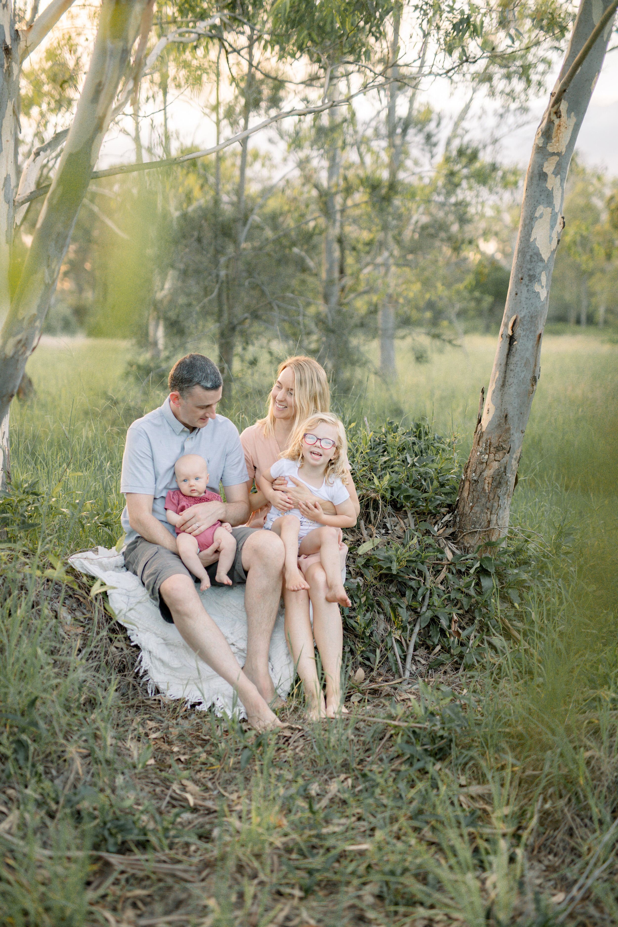 Family cuddling each other in the bushland