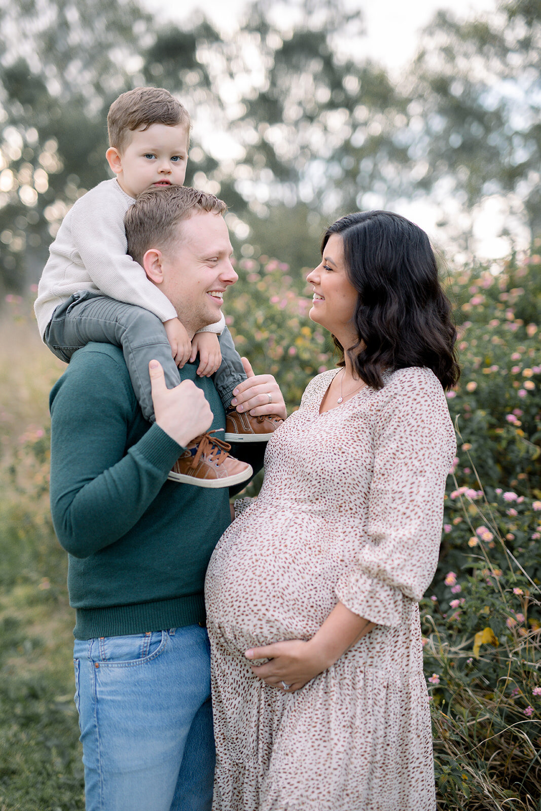 Expecting couple with their young son