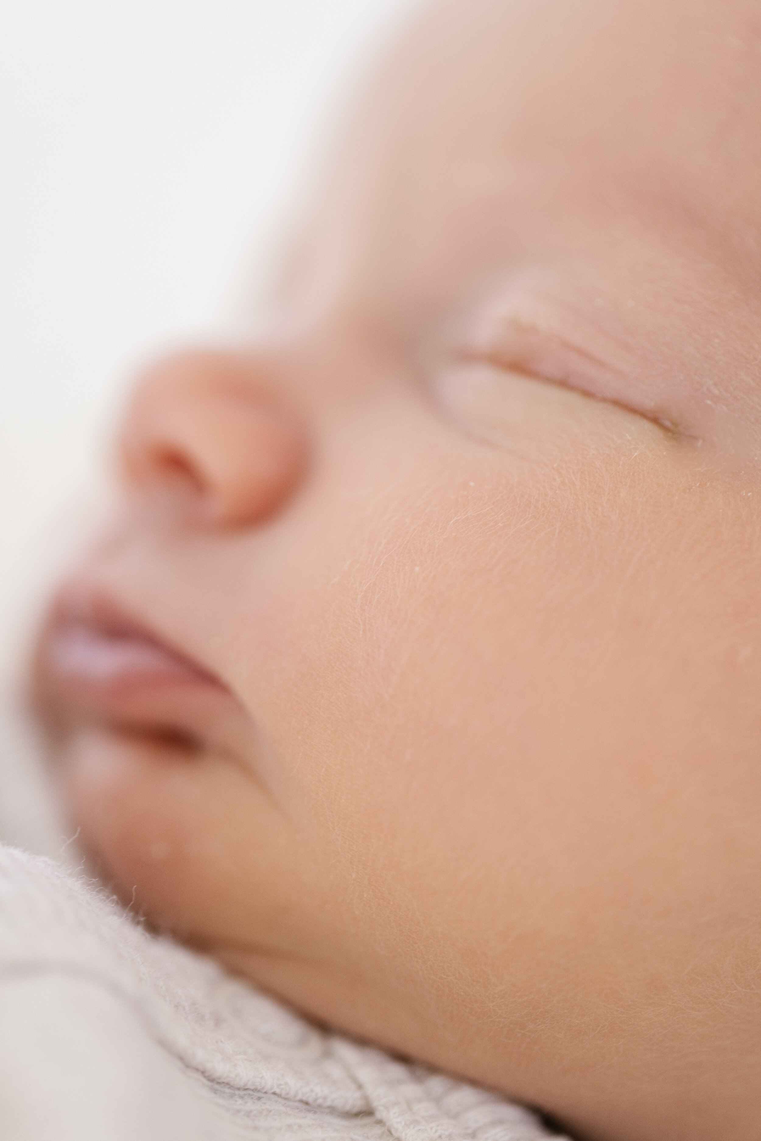 macro photograph of newborn baby cheek