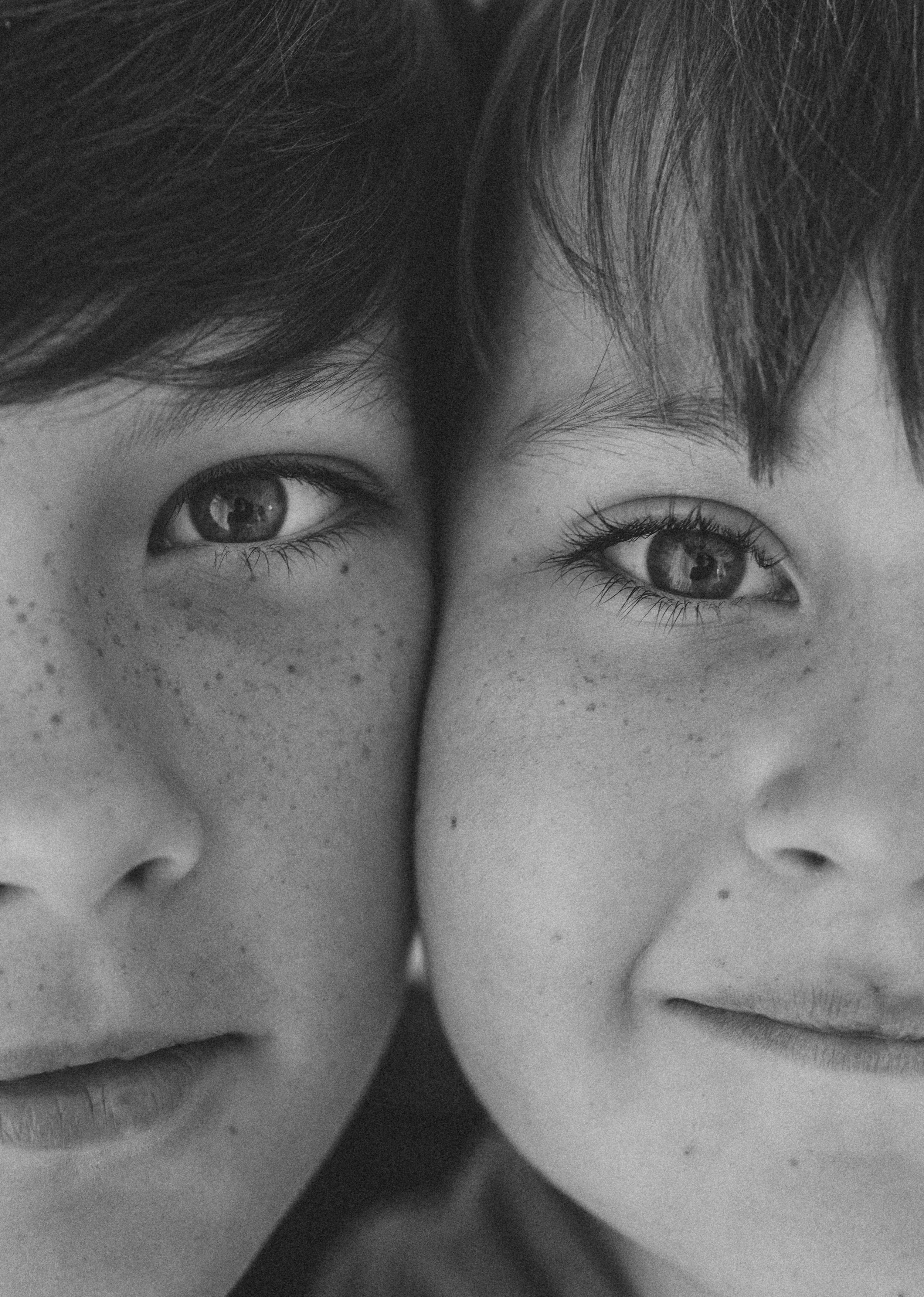 two boys face to face and close up in black and white