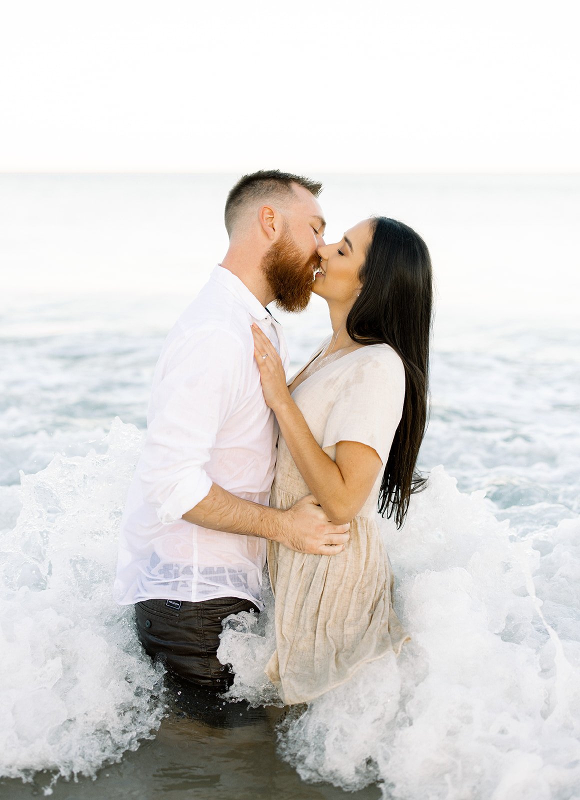 Sunshine coast engaged couple in crashing waves
