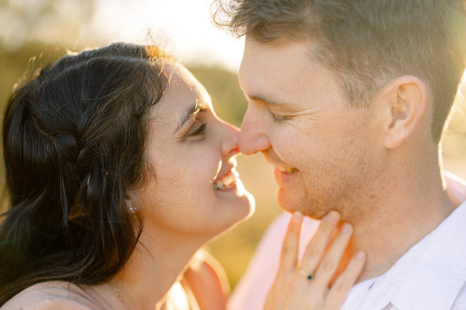 Couple about to kiss at sunset