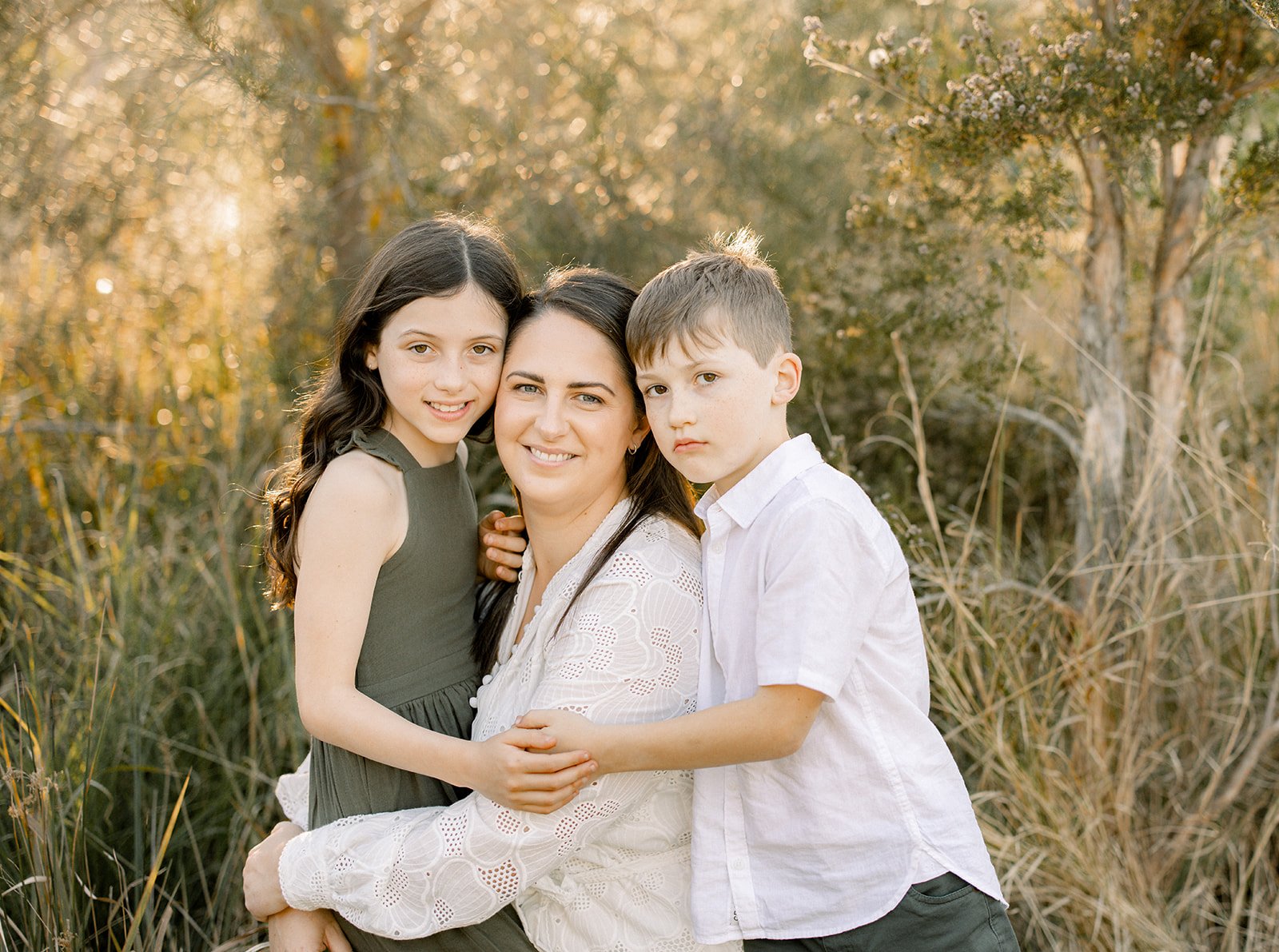 Mother smiling with her young daughter and son