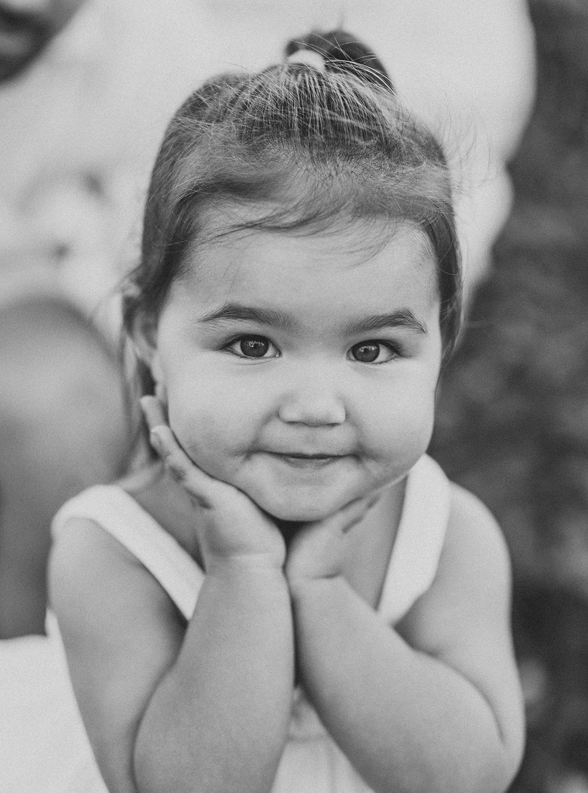 Blakc and white portrait of a little girl smiling at the camera