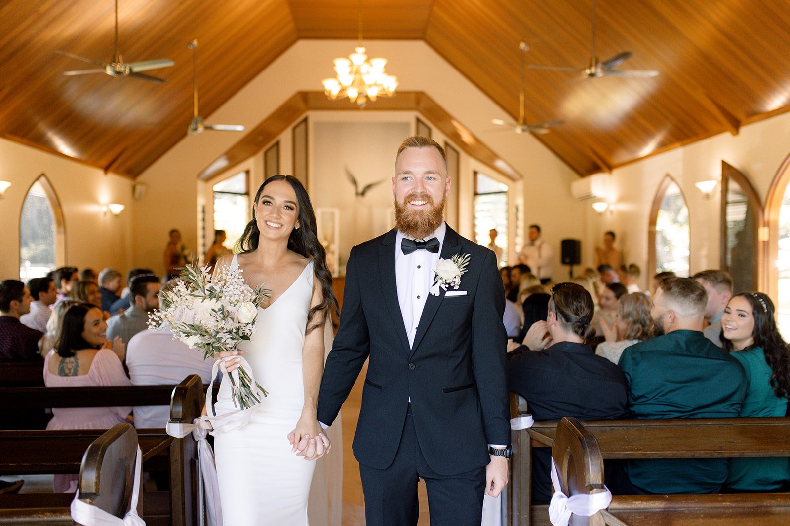 couple walk back down the aisle after their Sunshine Coast wedding ceremony