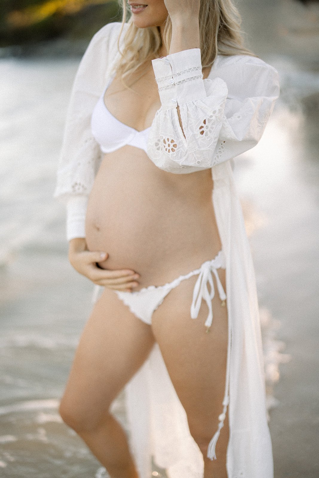 Close up of a pregnancy belly in a flowing white kimono