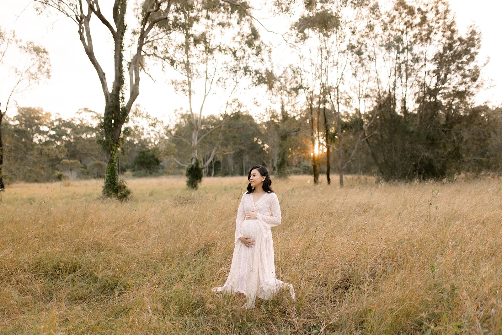 Brisbane pregnancy shoot, mum to be wearing a lace gown in bushland setting