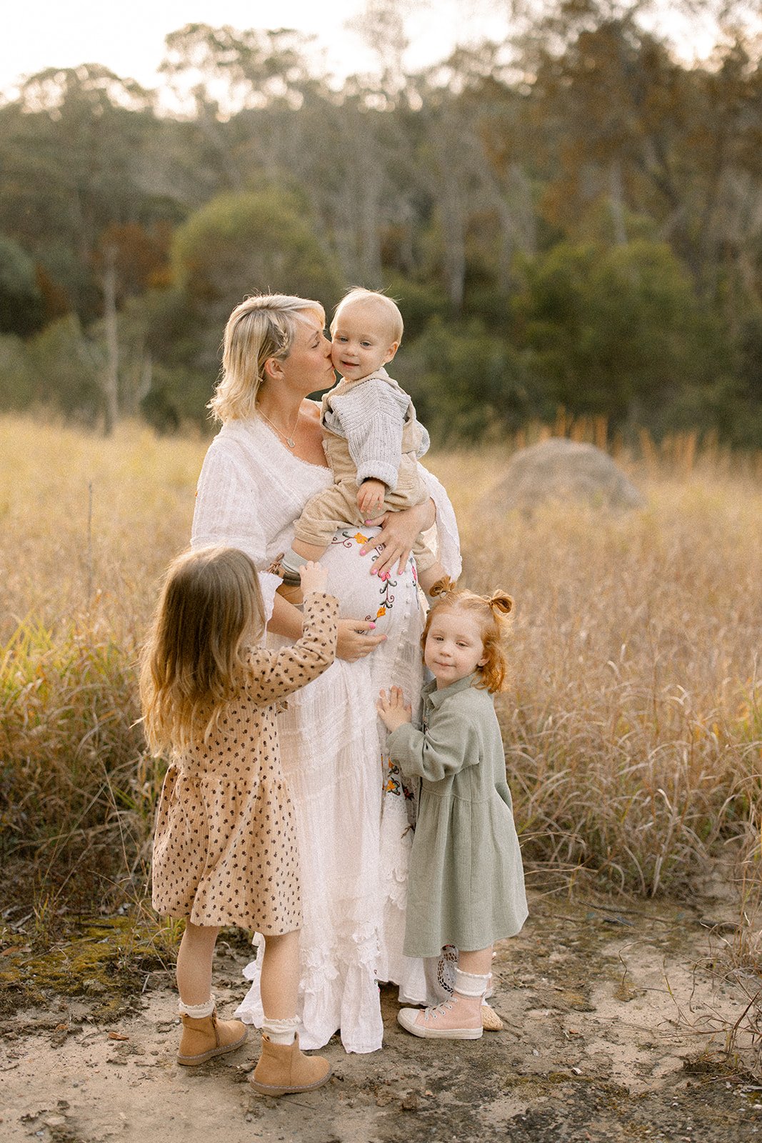 Pregnant mother gets cuddled by her children during Brisbane maternity photography session