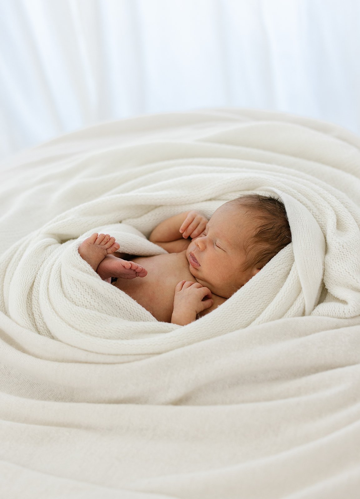 newborn baby girl wrapped in a blanket 