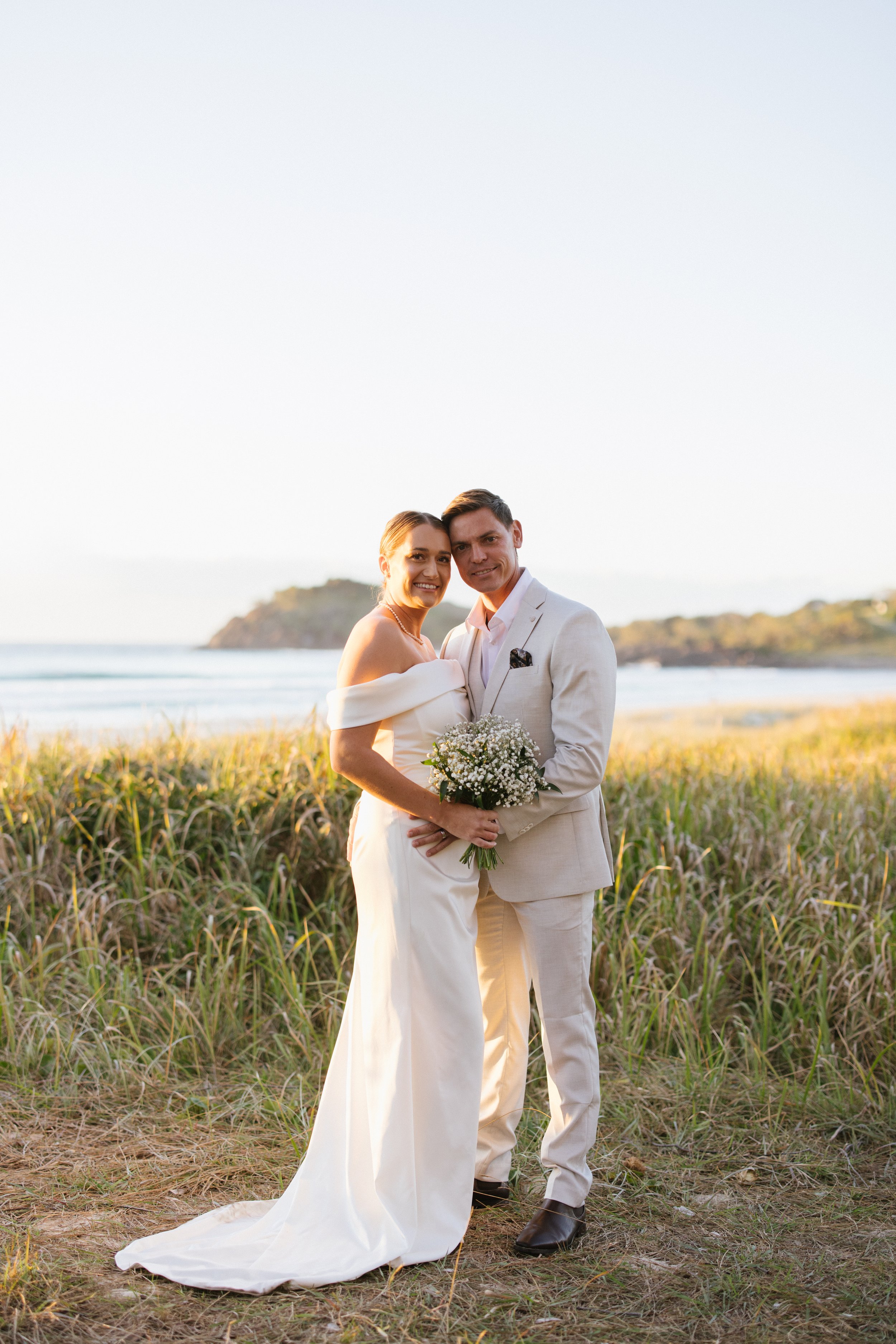 bride and groom at the beach at sunrise