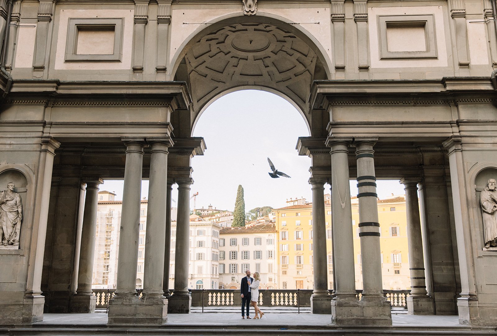 A photograph of a recently engaged couple standing in Florence Italy. 