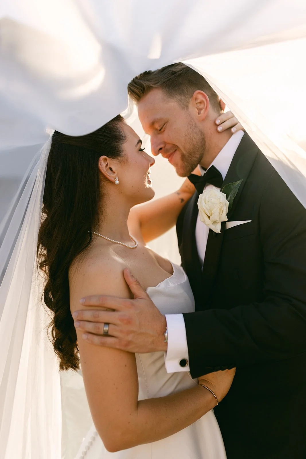 Bride and groom under the bride's veil