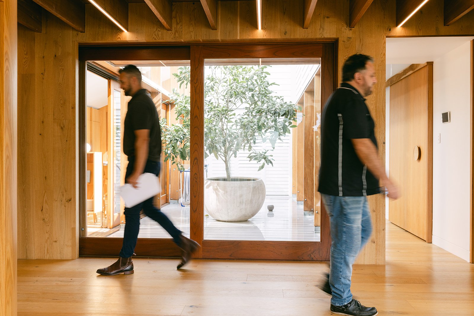 two builders walk in opposite directions during a branding photo shoot