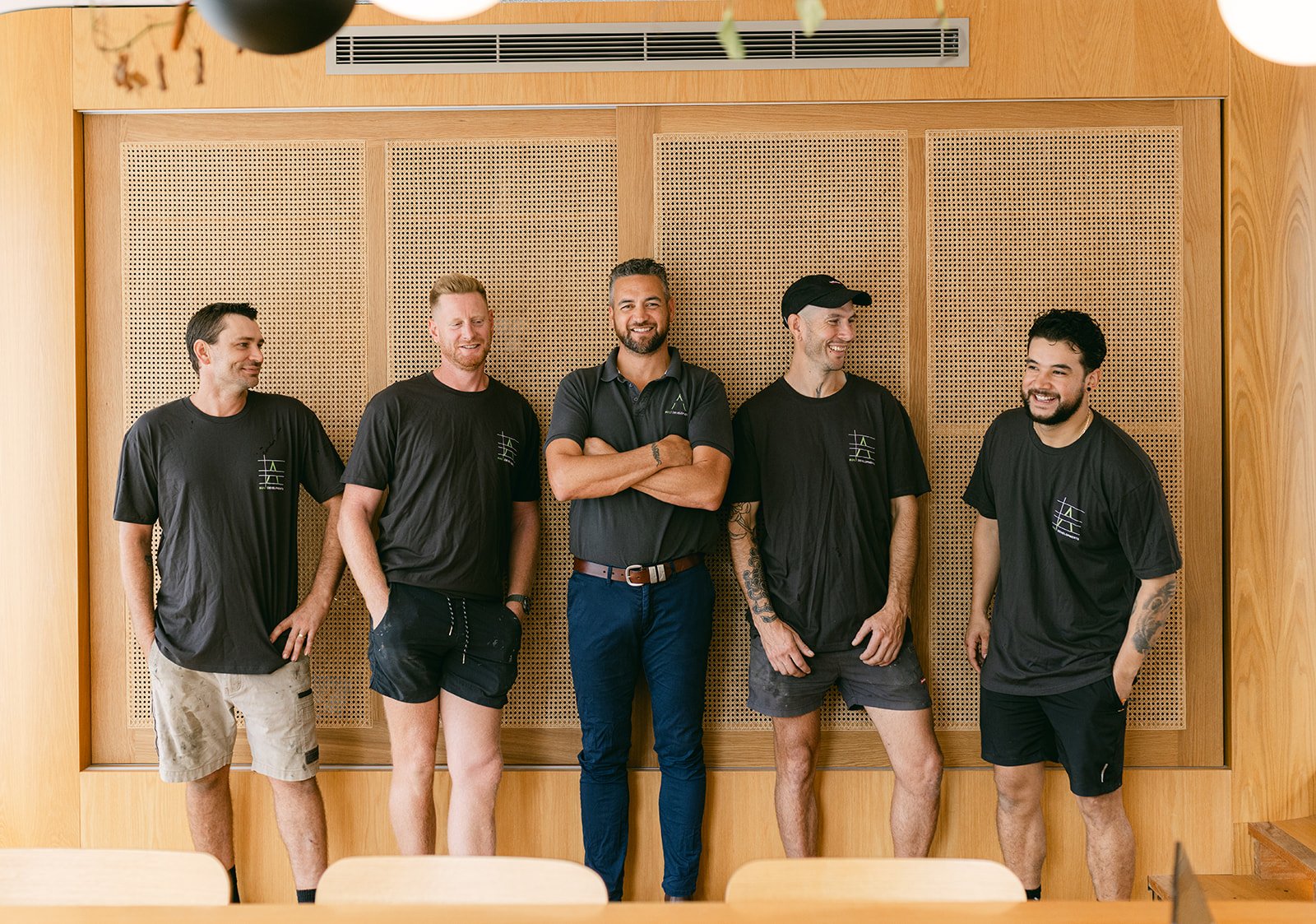 A bunch of builders stand together for a branding shoot