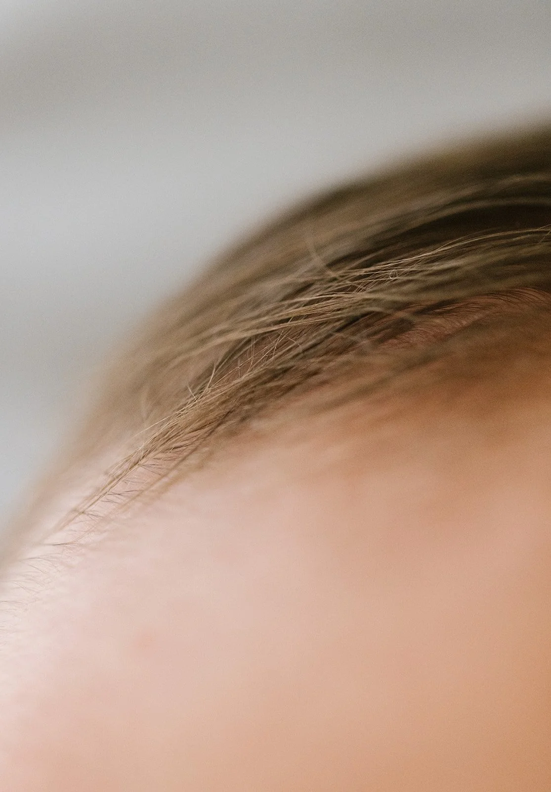 Close-up of a newborn baby's brown hair. Taken at Wylde Folk Studio, Brisbane.