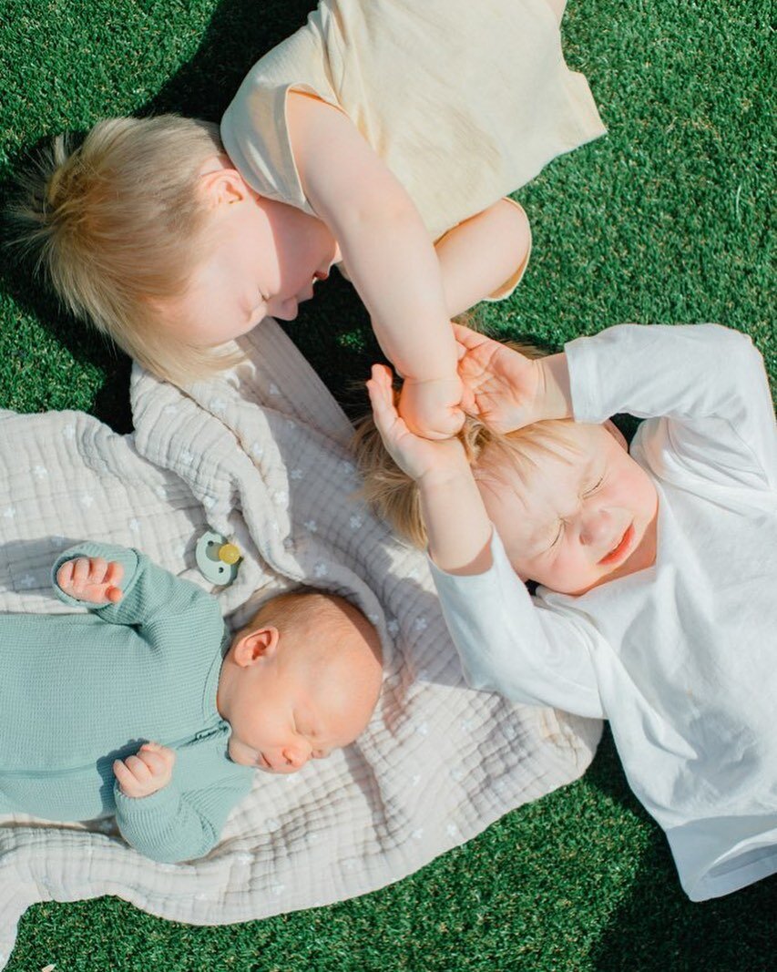 Easter photo 2023: the one that will never let us forget how hard it was to get three kids under three still and smiling for the camera. So here we are, squinty eyed, pulling hair &amp; laying in the middle of the church play ground all hyped up on j